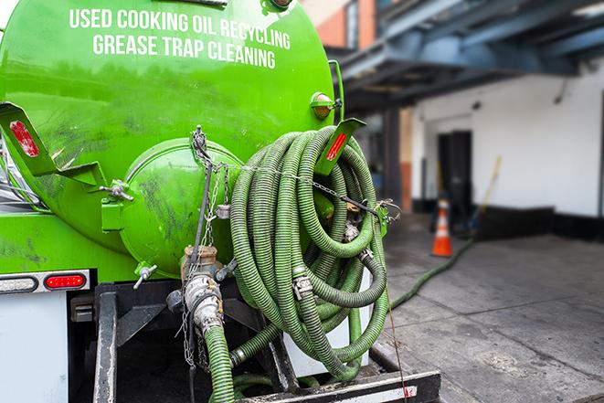 a large grease trap being pumped by a specialist in Amherst